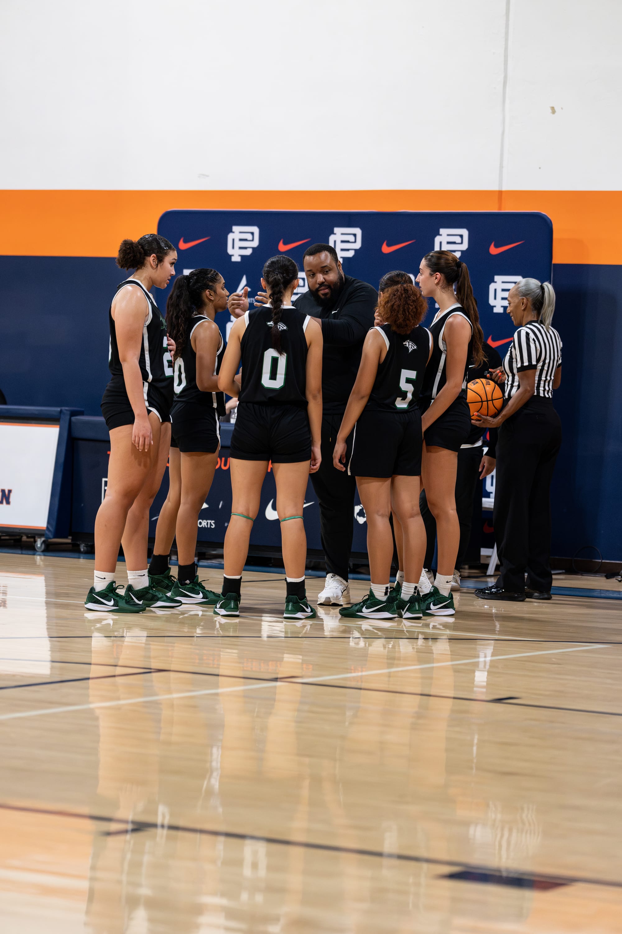 WE-R1 team huddle on the floor between possessions